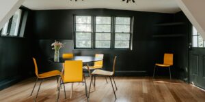 A dining room with yellow chairs and a table