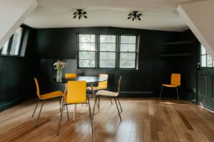 A dining room with yellow chairs and a table